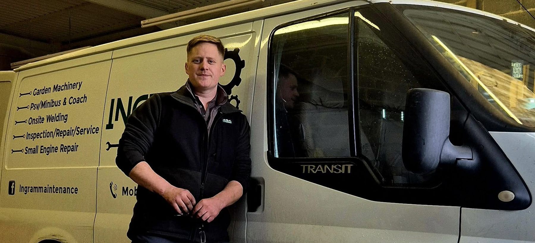 Ben Ingram beside the Ingram Maintenance Transit, with the service list signwritten on the side