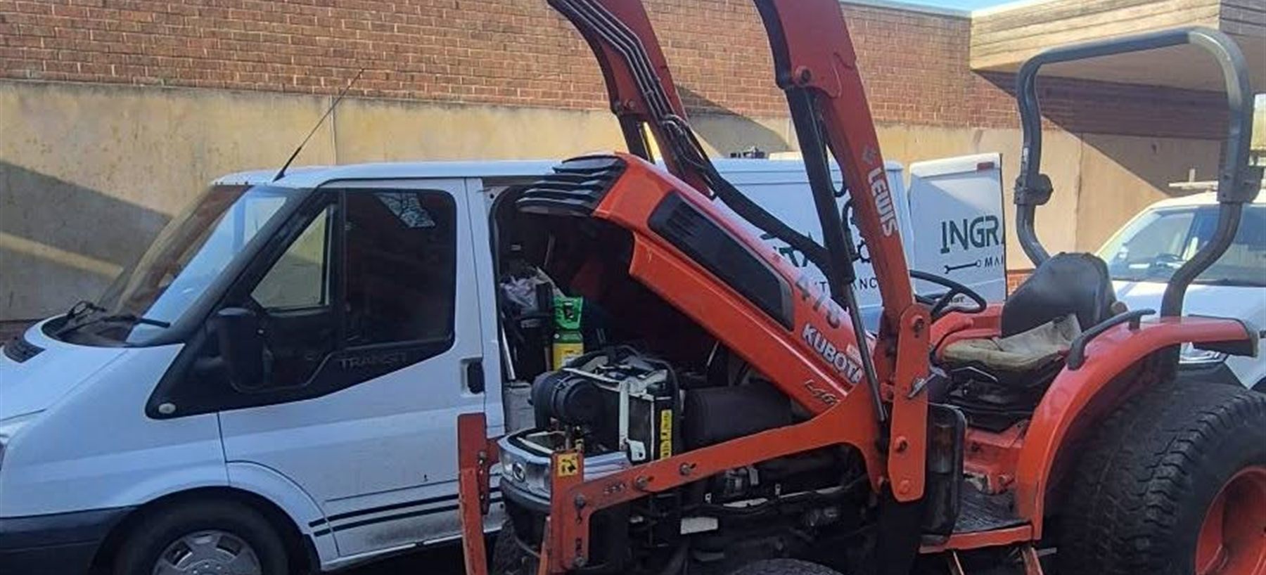 A Kubota compact tractor with a Lewis 380H front loader, alongside the Ingram Maintenance van
